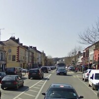 Red balaclava-wearing raider threatens supermarket staff