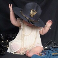 This photo of a baby girl wearing her fallen mother’s police hat has gone viral