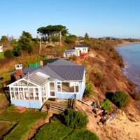 Cliff’s edge: Aerial footage shows how couple’s home is being slowly reclaimed by sea 