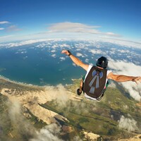 Thirteen skydivers parachute from burning plane after bird causes engine to go on fire