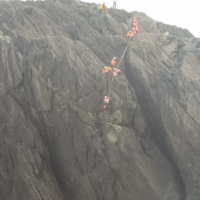 Man rescued from cliff ledge after falling into the sea
