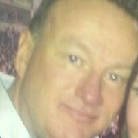 Woman arrested and police call for calm after 'reckless' murder of prominent loyalist 