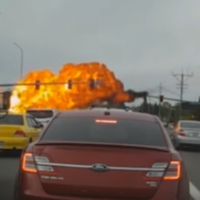 Somehow nobody was injured when this plane hit power lines and crashed onto a road