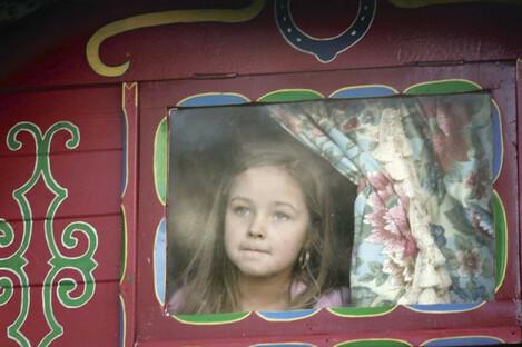 Kelsey Casey, aged 6 from Southhill, Limerick looks out from a decorated wagon window during a protest march.