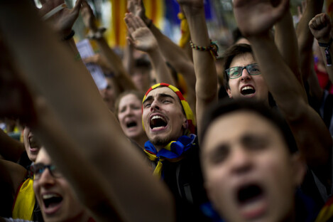 People gesture and shout slogans during a protest in Barcelona. 