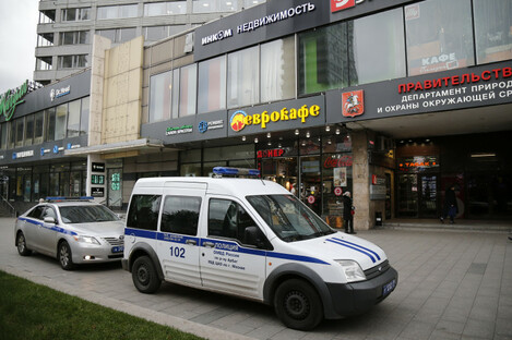 Police vehicles parked outside a building where the Ekho Moskvy radio station is located