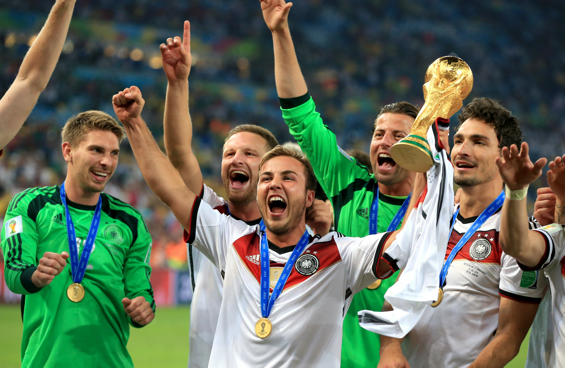 Gotze lifts the World Cup trophy alongside German team-mates four years ago. Image Nick Potts