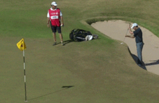 Golfer putts from bunker with the ball at waist height
