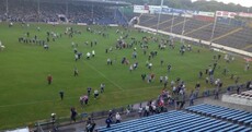 Fans stream across Semple Stadium pitch during teams' warm-up as minor final delayed