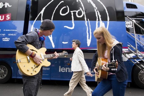 Two young guitarists play outside the John Lennon Educational Bus.