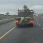 Dancing trousers do a jig on back of moving truck