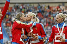 Russian sprinters appear to protest 'anti gay' law with podium kiss