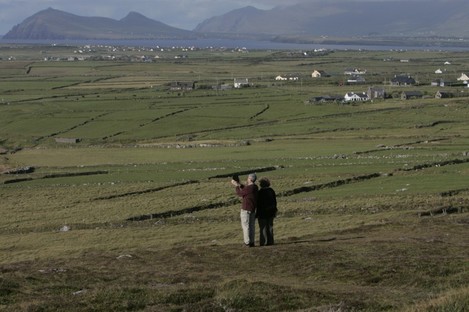 Tourists use their iPad to video the landscape as the Atlantic Ocean reaches land near Clogher Head on the Dingle Peninsula.