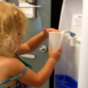 Little girl uses water cooler, doesn't quite get it right
