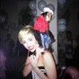 Miley Cyrus poses with a monkey dressed as a cowboy on her back