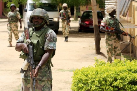 Nigerian soldiers stand guard at the offices of the state-run TV station. (Dated 6 June)