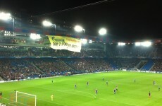 Greenpeace protesters abseil from stadium roof during Champions League match