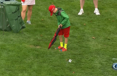 Young Tiger Woods fan takes the perfect imaginary putt