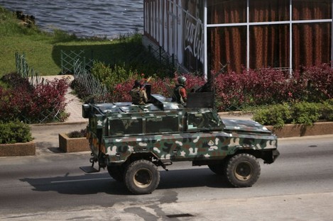 Troops supporting former president Laurent Gbagbo drive past in a armoured car in the city of Abidjan.