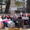 Students protest cuts to social welfare by eating beans on a couch at Leinster House