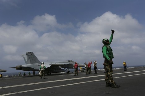 An F/A-18 Super Hornet prepares to take off from the deck of the USS George Washington 