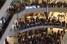 Man arrested for flinging money from 4th floor of shopping centre