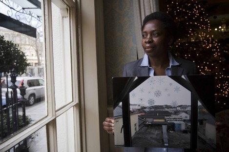 Simmy Ndlovu, originally from Zimbabwe, holds a photograph of a view from a Direct Provision centre