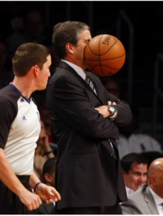 Perfectly timed photo captures the moment a coach is hit in the face with a basketball