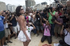 Topless rights protest attracts just four women... and over 100 photographers