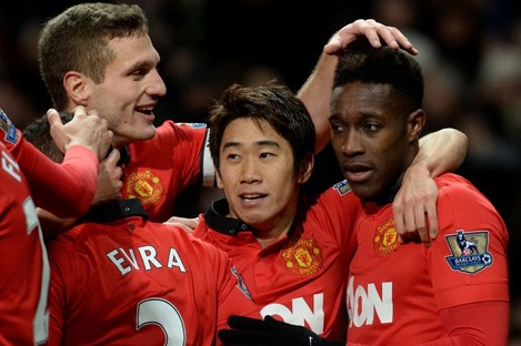 Manchester United's Danny Welbeck (right) celebrates with Shinji Kagawa and Nemanja Vidic.