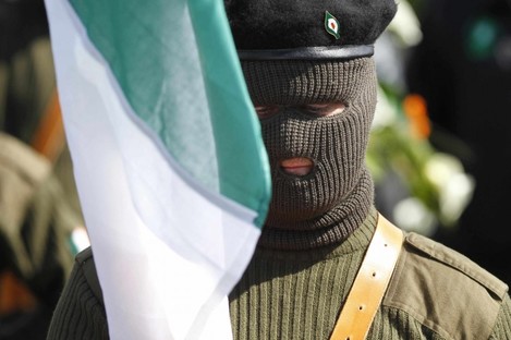 A masked member of the Real IRA parades during a 1916 Easter Rising commemoration at Cregan Cemetery in Derry earlier today.