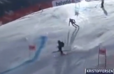 Downhill competitor narrowly avoids carnage as stray skier drifts into path