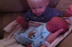 Two-year-old meets his baby brother for the first time