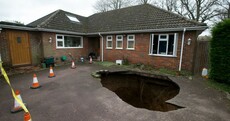 Well hole-y god: Giant sinkhole swallows family car
