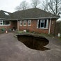 Well hole-y god: Giant sinkhole swallows family car