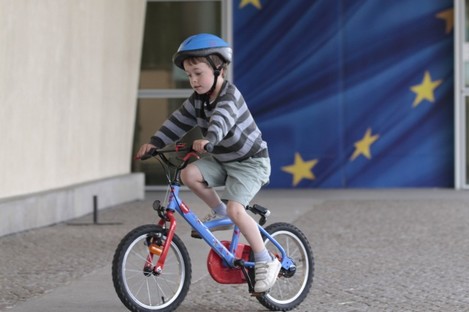 A boy cycles past the entrance of the European Commission headquarters in Brussels earlier today. The EC was closed today to mark Europe Day.