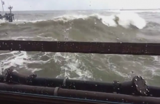 Huge wave smashes through restaurant window as people eat breakfast