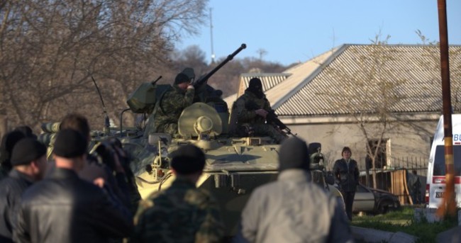 Russian forces storm Ukraine airbase. Reports of soldier shot.