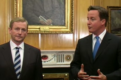 Britain's prime minister David Cameron speaks to the media as Taoiseach Enda Kenny looks on.