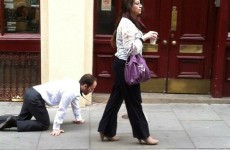 A businessman is being walked around London on a lead