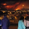 Sixteen people have died in a huge fire consuming the outskirts of a Chilean port city