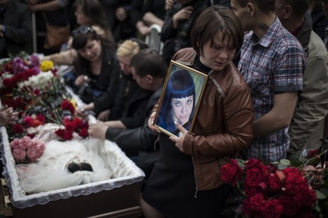 Mourners at the funeral of a 21-year-old believed to be killed by shots from a Ukrainian military column.