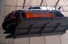 Argh! Rally car rolls off platform while being transported by a crane