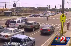 Watch this motorcyclist flip and land on his feet after crashing into a car