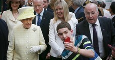 Say cheese! Kid tries to take a selfie in front of Queen Elizabeth