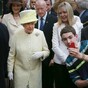 Say cheese! Kid tries to take a selfie in front of Queen Elizabeth