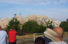 Watch this guy's incredible near-miss with a stray rock from an explosion
