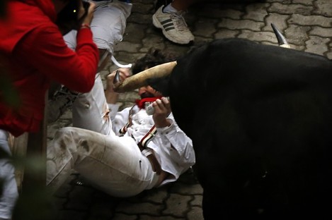 Bill Hillman struggles with a bull after being gored at the San Fermin festival in Pamplona. 