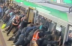 Passengers use collective strength to push train off trapped man