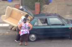 Watch three people trying to stuff one large sofa into a small car